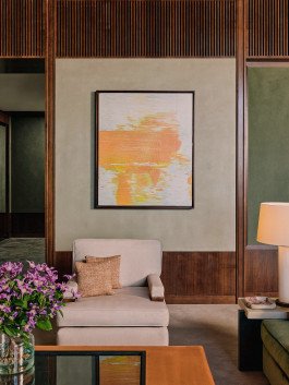 Rosewood Art: Contemporary living room featuring abstract art, plush armchair, and stylish interior design elements. 
