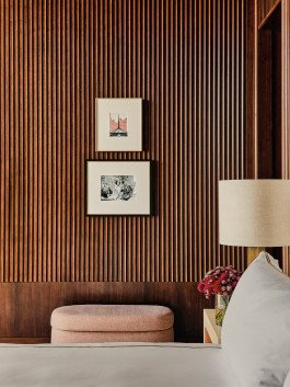 Rosewood Art: Kensington Leverne photography featuring wood paneling, framed art, and stylish bedroom decor. 