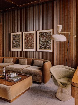 Living Room: Brown sofa, Rosewood art prints, and mid-century modern lamp. Kensington Leverne Photography showcases elegant interior design. 